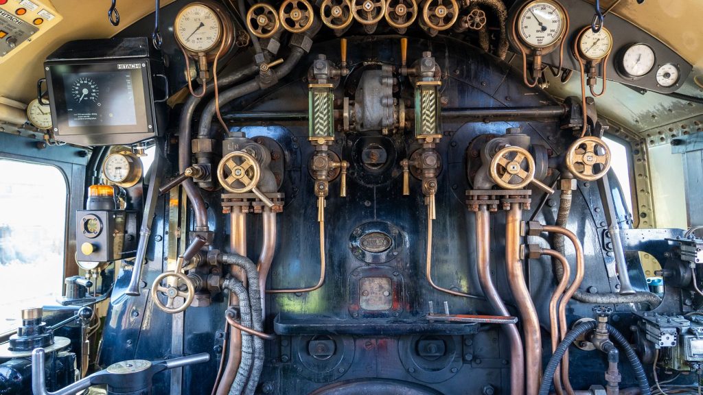 The intricate controls of a vintage steam locomotive, showcasing a blend of engineering and craftsmanship.