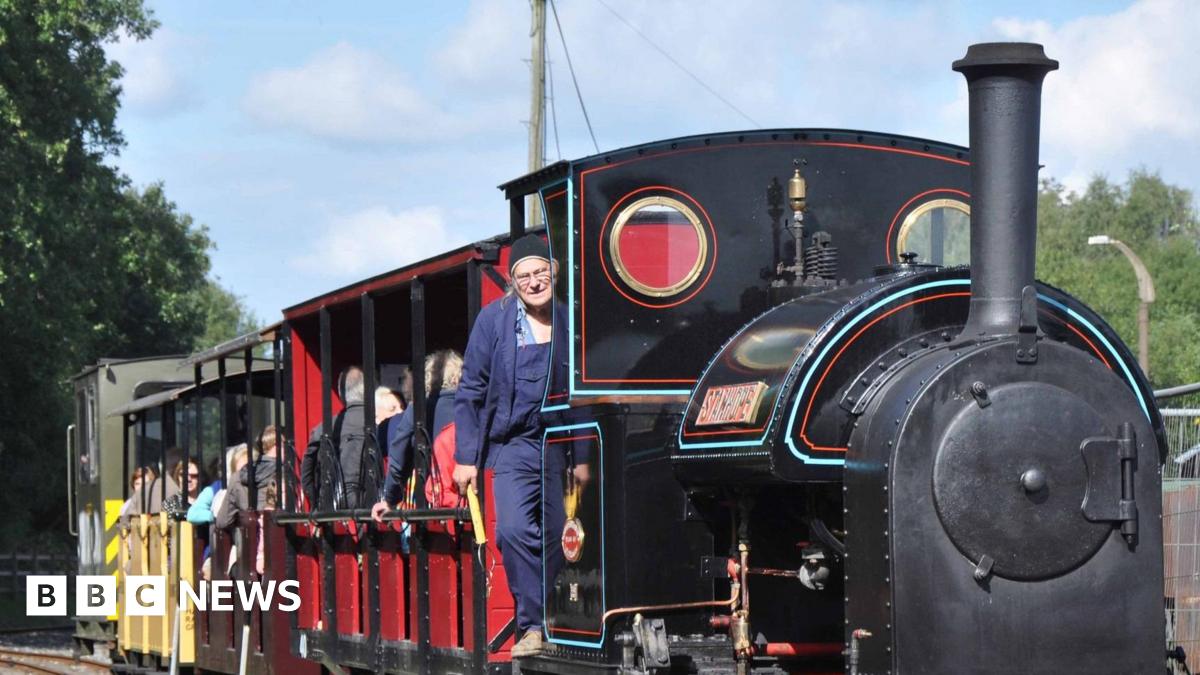 A steam train makes its way through the countryside, bringing joy to its passengers.