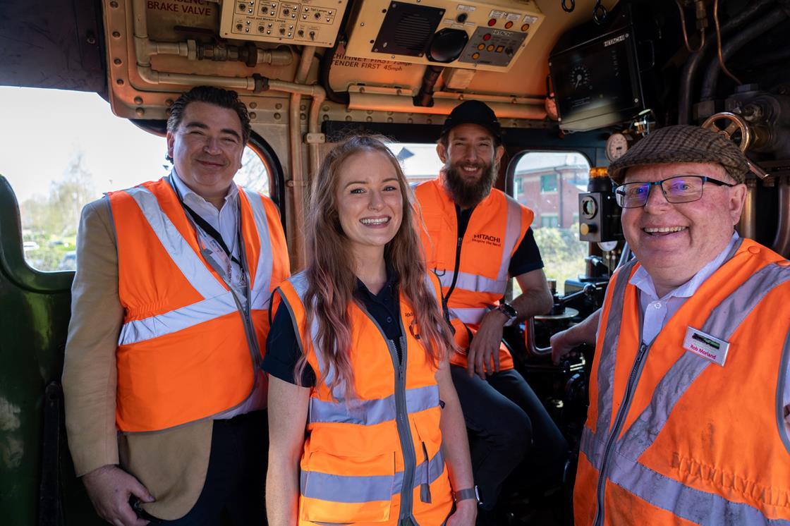 Celebrating teamwork and safety aboard the locomotive.