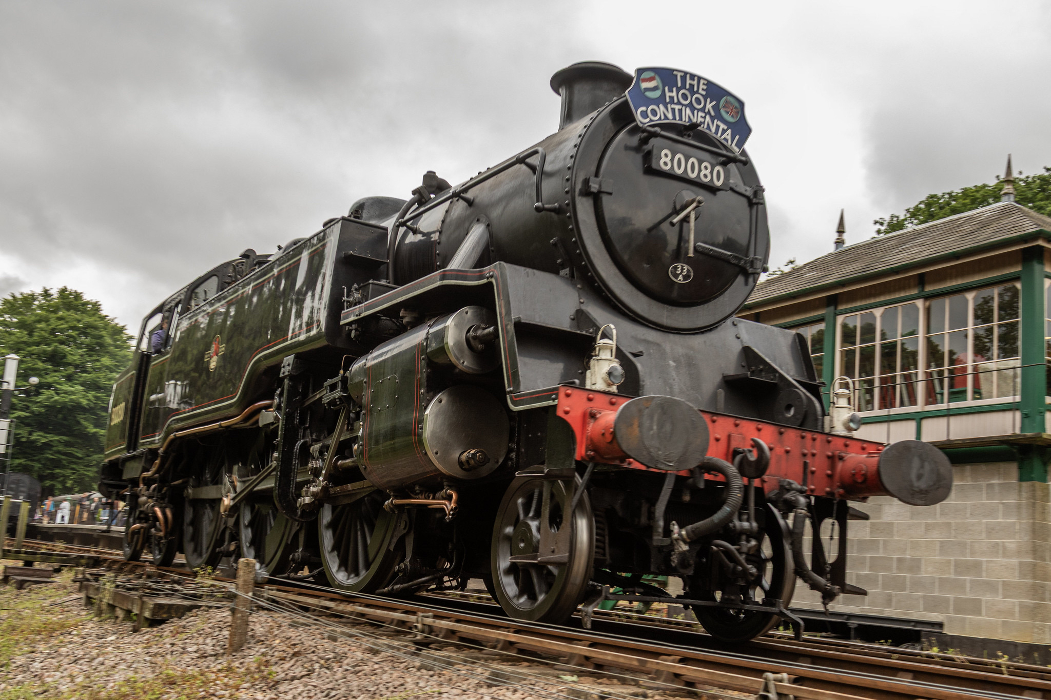 A majestic steam locomotive in motion at the railway station.
