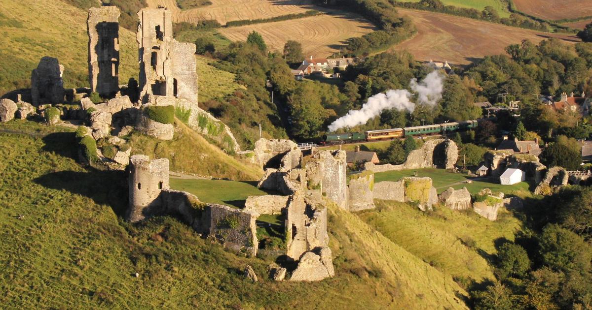 A historic blend of ruins and railway, surrounded by picturesque countryside.